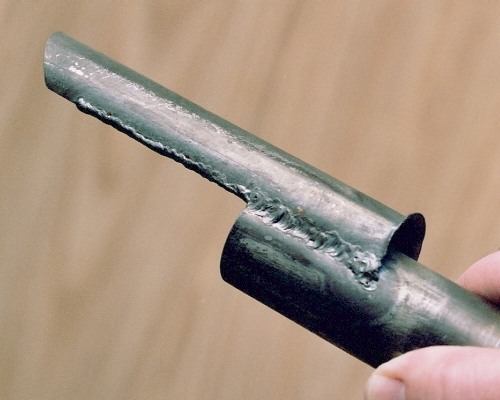 Side view of the weld joining the intake half-shell to the notched tailpipe front end, before shaping the front end of the spout lip. Photo Copyright 2005 Larry Cottrill