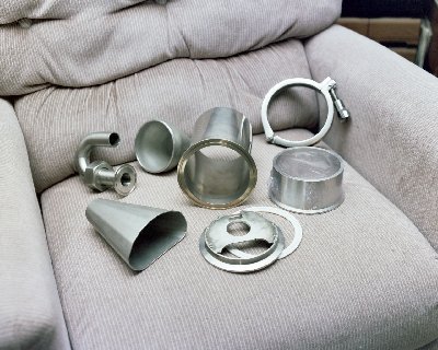 Cyclodyne engine front end parts, except for a few special cut <br />sheet SS pieces that would be needed to make the hollow 'tower' <br />to support the fuel nozzle. Photo Copyright 2004 Larry Cottrill